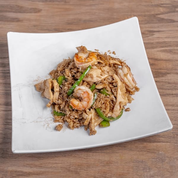 Chaba Thai Restaurant's fried rice with chicken, shrimp, and green beans on a white plate.