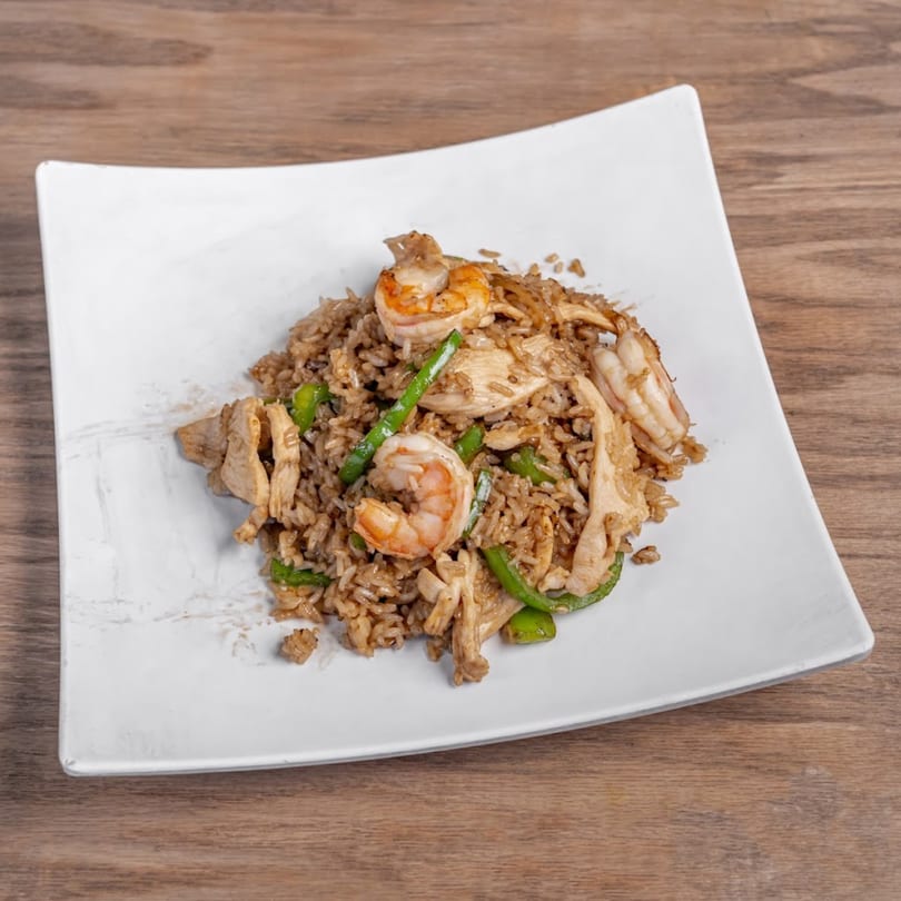 Chaba Thai Restaurant's fried rice with chicken, shrimp, and green beans on a white plate.